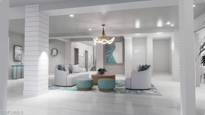 1 Bluebill Avenue, Unit 410 Naples, FL 34108 - Photo 31 of 36 a living room with furniture a chandelier and a chandelier