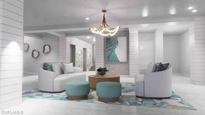 1 Bluebill Avenue, Unit 410 Naples, FL 34108 - Photo 36 of 36 a living room with furniture and a chandelier