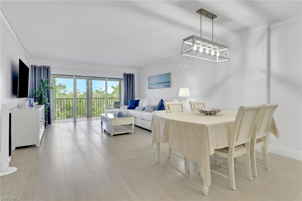 1 Bluebill Avenue, Unit 410 Naples, FL 34108 - Photo 5 of 36 a view of a livingroom with furniture window and wooden floor