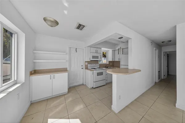 a kitchen with granite countertop cabinets and white appliances
