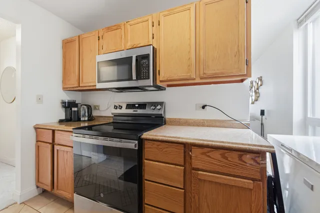 a bedroom with a bed and flat tv screen on the dresser