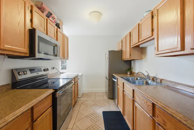 a bathroom with a double vanity sink toilet and shower