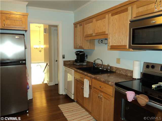 3325 Lancelot Road Petersburg, VA 23805 - Photo 3 of 12 a kitchen with stainless steel appliances granite countertop a sink stove and cabinets