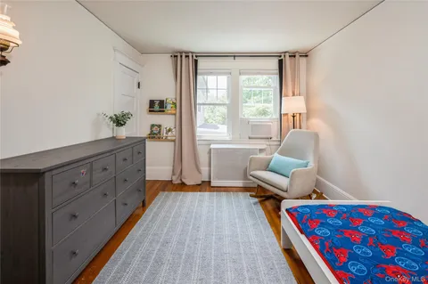 a bedroom with furniture and a window