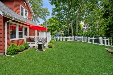 a view of a house with a yard and sitting area