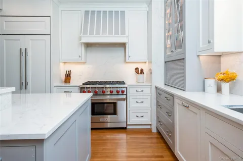 a kitchen with stainless steel appliances a sink stove and cabinets