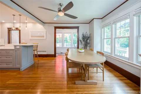 a view of a dining room with furniture window and wooden floor