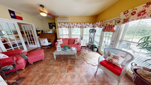 a living room filled with furniture and a book shelf