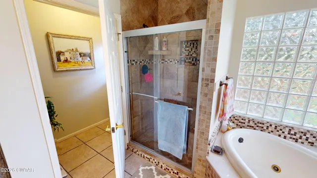 a bathroom with a tub and a shower