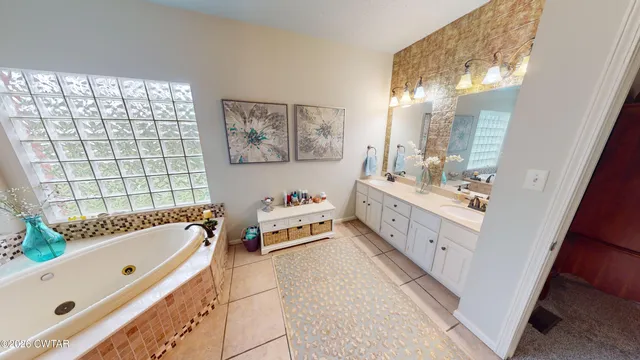 a bathroom with a bathtub a sink a toilet and a shower