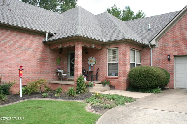 a front view of a house with a garden and plants