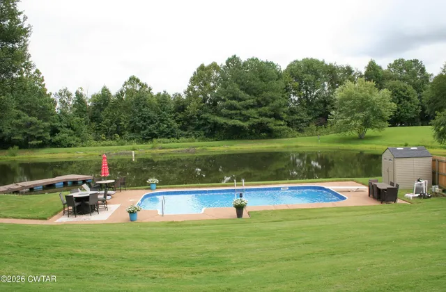 a view of a house with a yard and a porch