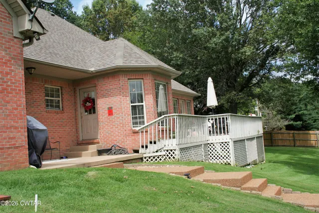 a view of a swimming pool with a yard