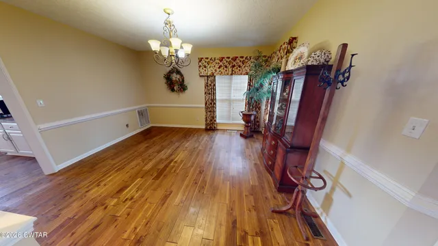 a view of a room with wooden floor and staircase