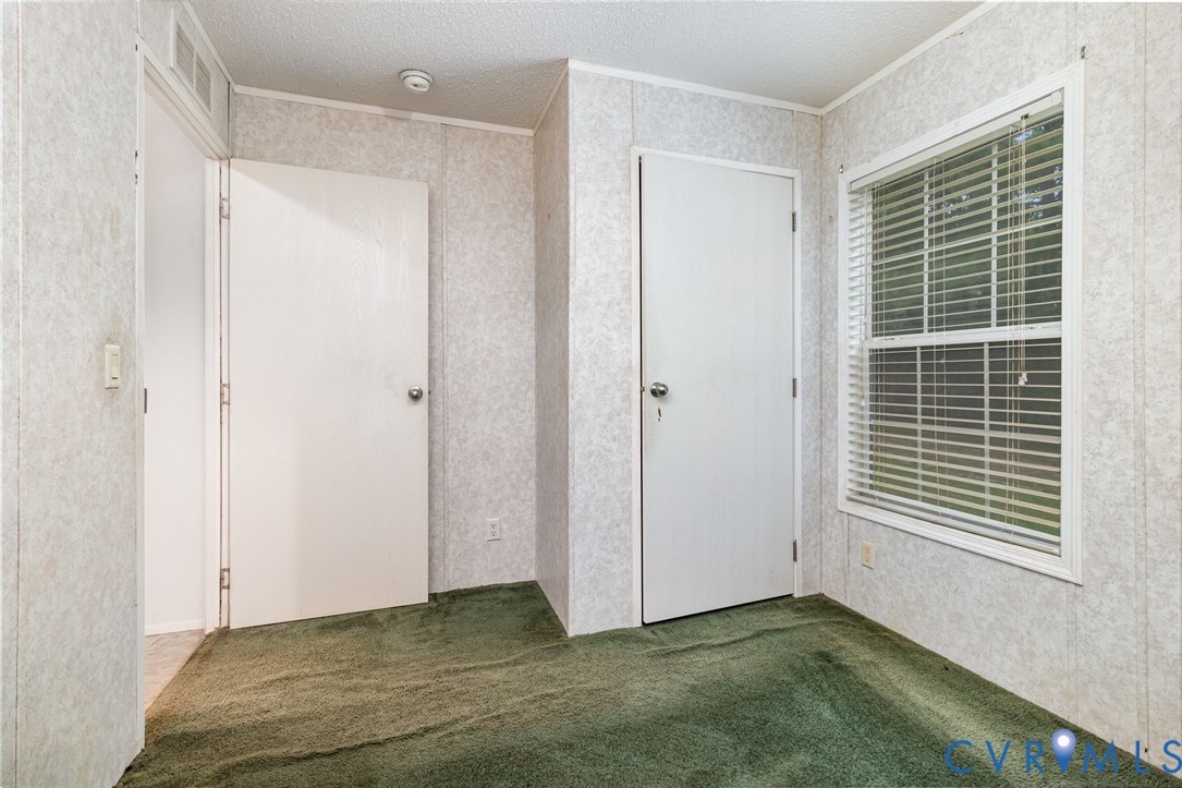 1292 Mt Prospect Road Laneview, VA 22504 - Photo 15 of 25 a view of an empty room with windows and wardrobe