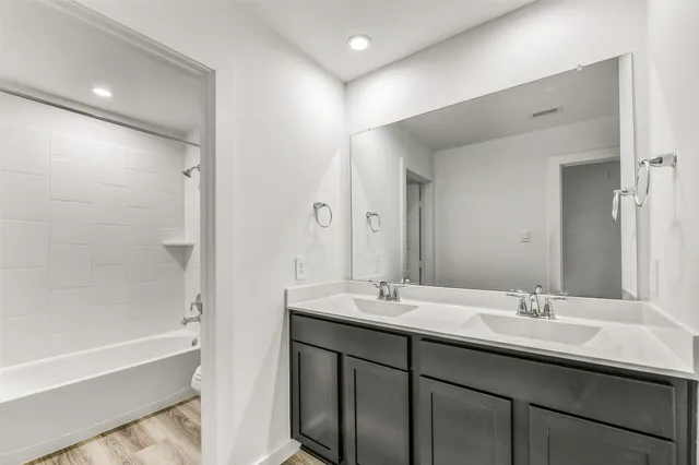 an empty room with ceiling fan and window