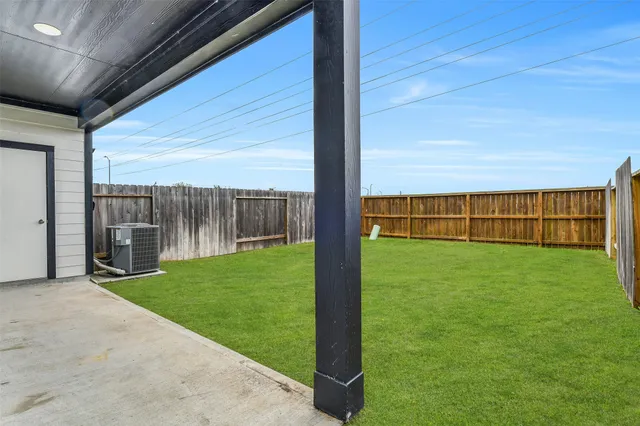 a backyard of a house with table and chairs