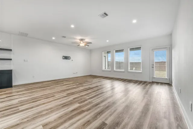 a view of a kitchen with sink and dishwasher with wooden floor
