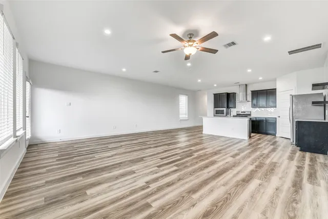 a view of a kitchen with a sink and a refrigerator