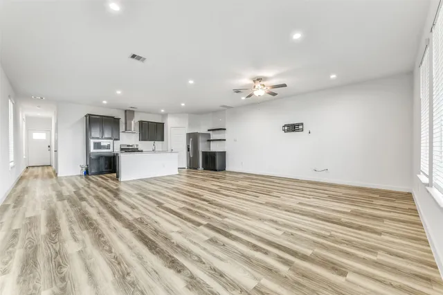 a view of kitchen with sink microwave and refrigerator