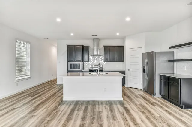 a kitchen with a sink stove and refrigerator