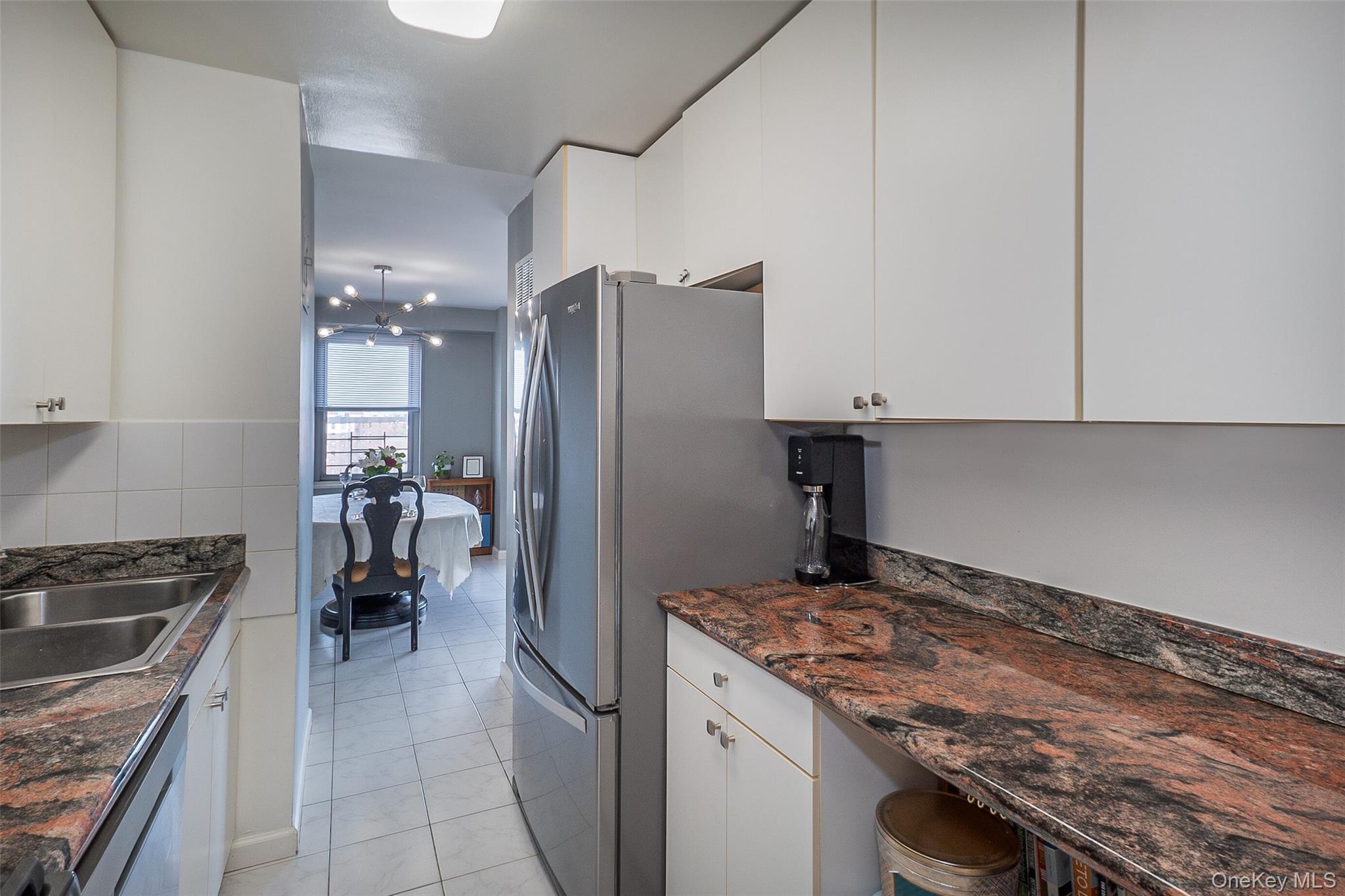 85-15 Main Street, Unit J12 Queens, NY 11435 - Photo 13 of 26 a kitchen with a stove and a refrigerator