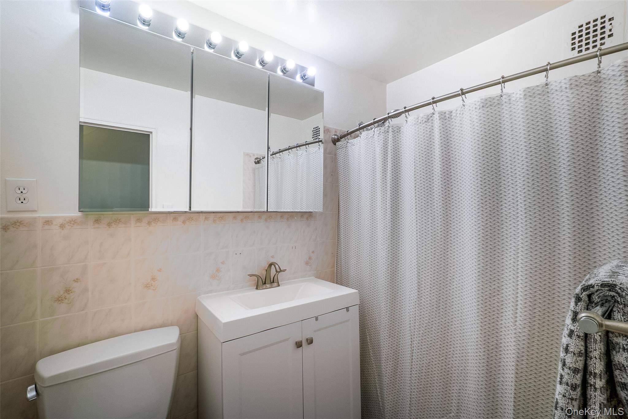 85-15 Main Street, Unit J12 Queens, NY 11435 - Photo 18 of 26 a bathroom with a sink and a mirror