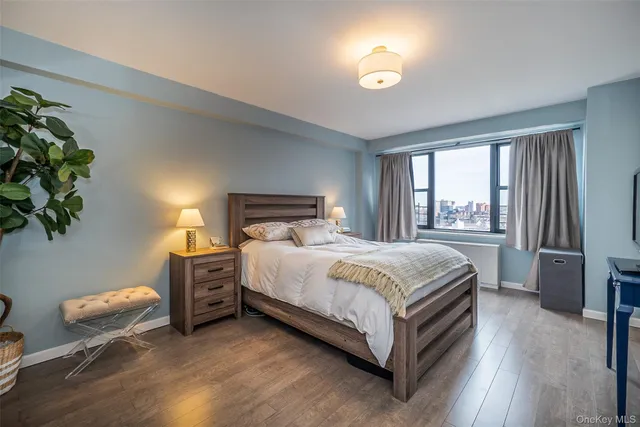 a bedroom with a bed and a flat tv screen on a dresser