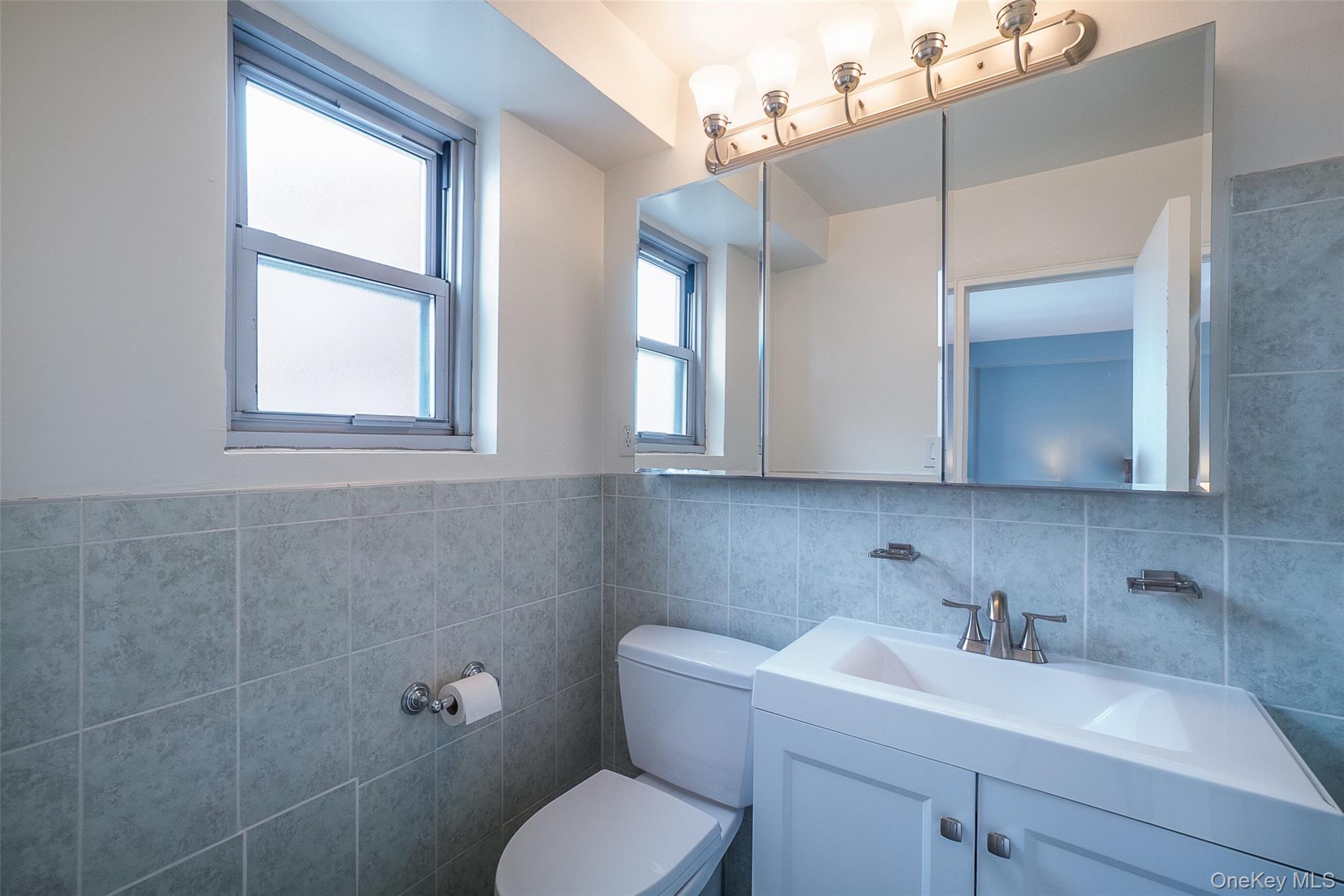 85-15 Main Street, Unit J12 Queens, NY 11435 - Photo 22 of 26 a bathroom with a toilet sink and window