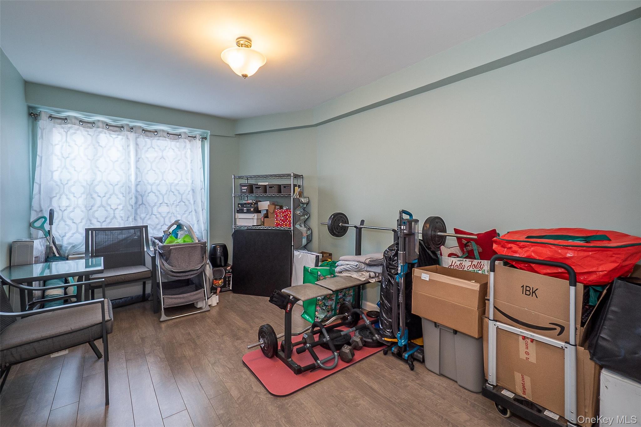 85-15 Main Street, Unit J12 Queens, NY 11435 - Photo 24 of 26 a living room with furniture and a wooden floor