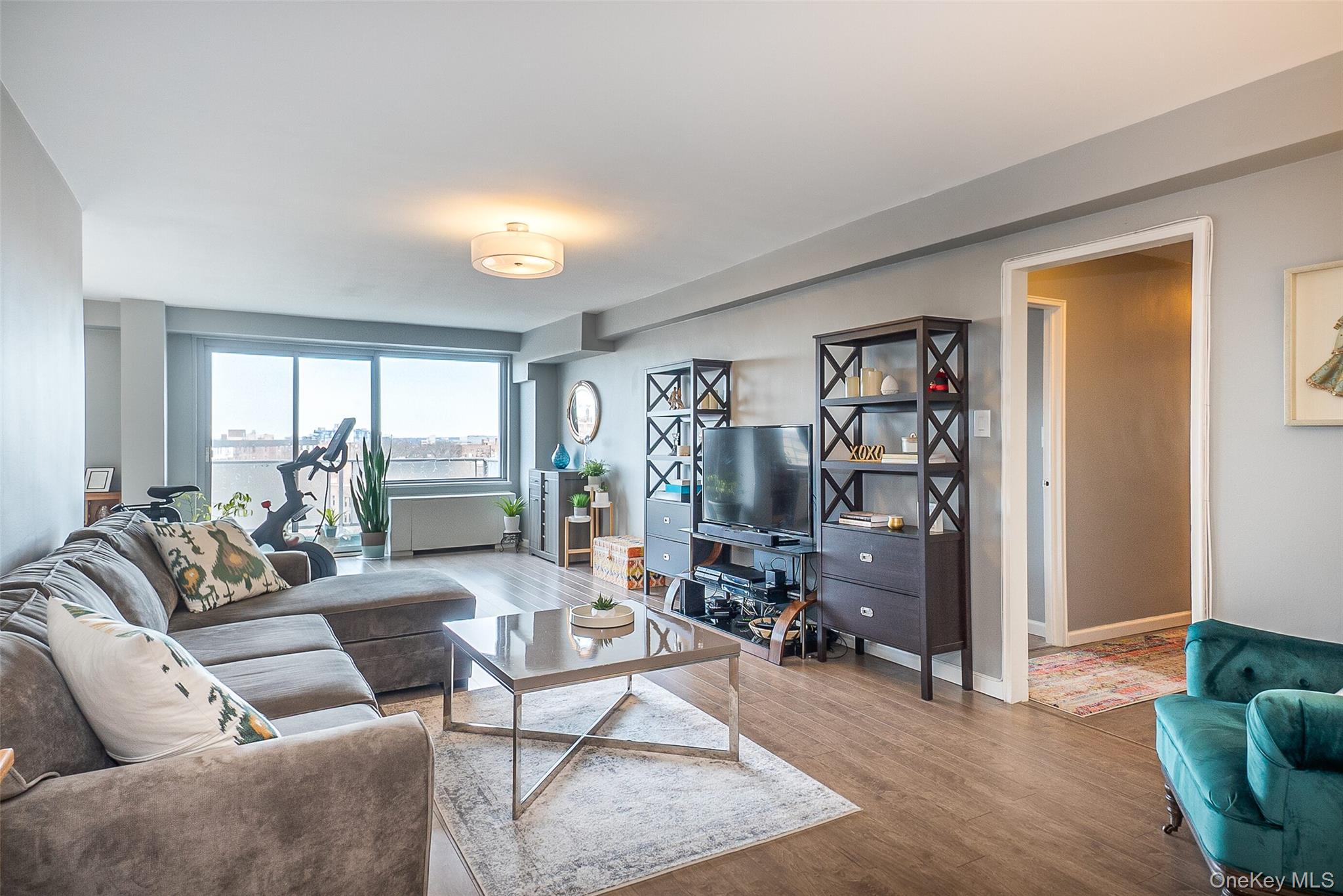 85-15 Main Street, Unit J12 Queens, NY 11435 - Photo 5 of 26 a living room with furniture and a window