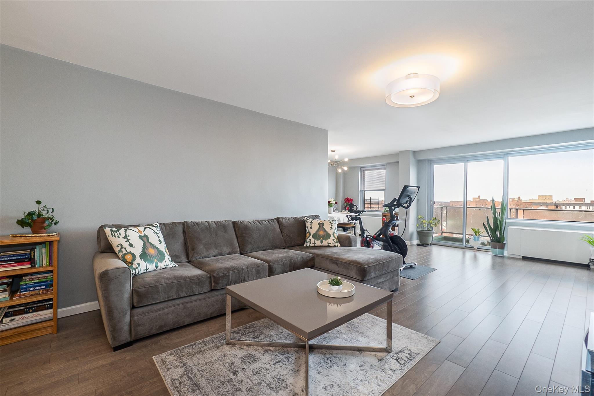 85-15 Main Street, Unit J12 Queens, NY 11435 - Photo 7 of 26 a living room with furniture and a large window