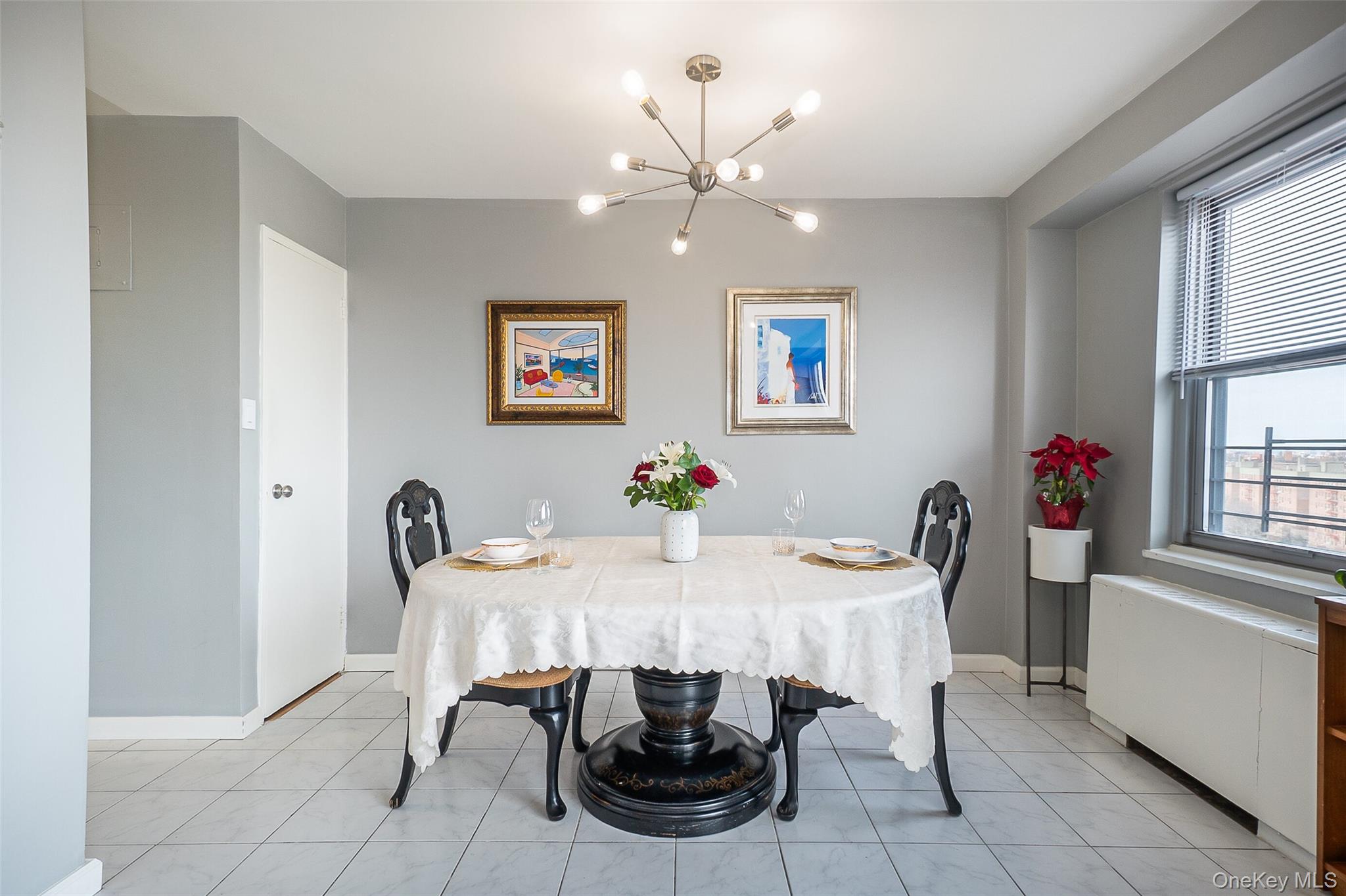 85-15 Main Street, Unit J12 Queens, NY 11435 - Photo 10 of 26 a view of a dining room with furniture and chandelier