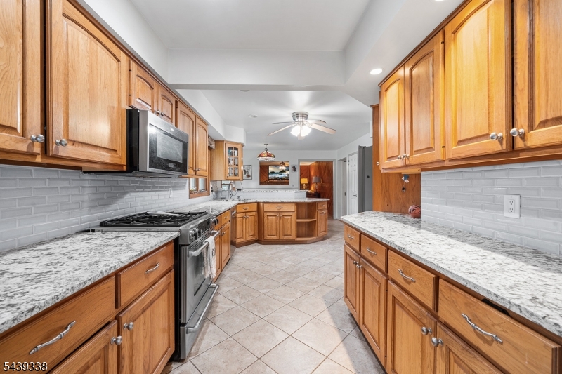 1 Oak Grove Road Flemington, NJ 08822 - Photo 11 of 29 a kitchen with stainless steel appliances granite countertop a stove a sink and a microwave