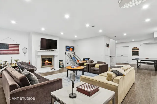 a living room with furniture a flat screen tv and a fireplace