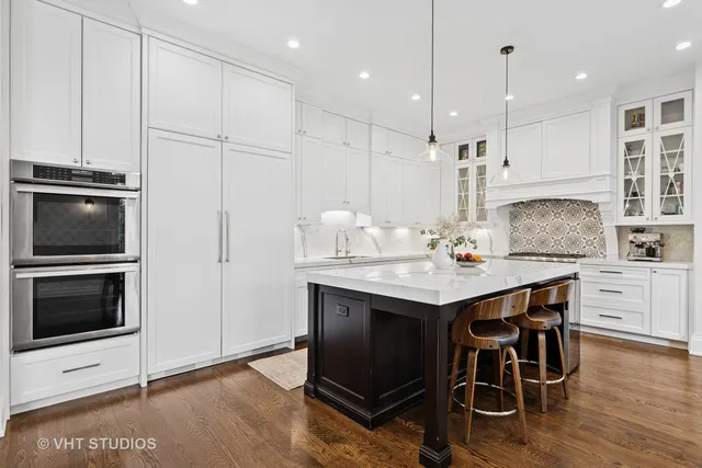 a kitchen with stainless steel appliances kitchen island granite countertop a stove a sink and a microwave