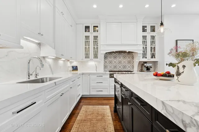 a kitchen with sink stove and cabinets