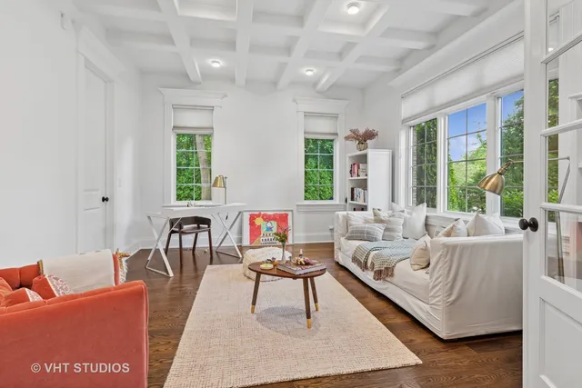 a living room with furniture wooden floor and a large window