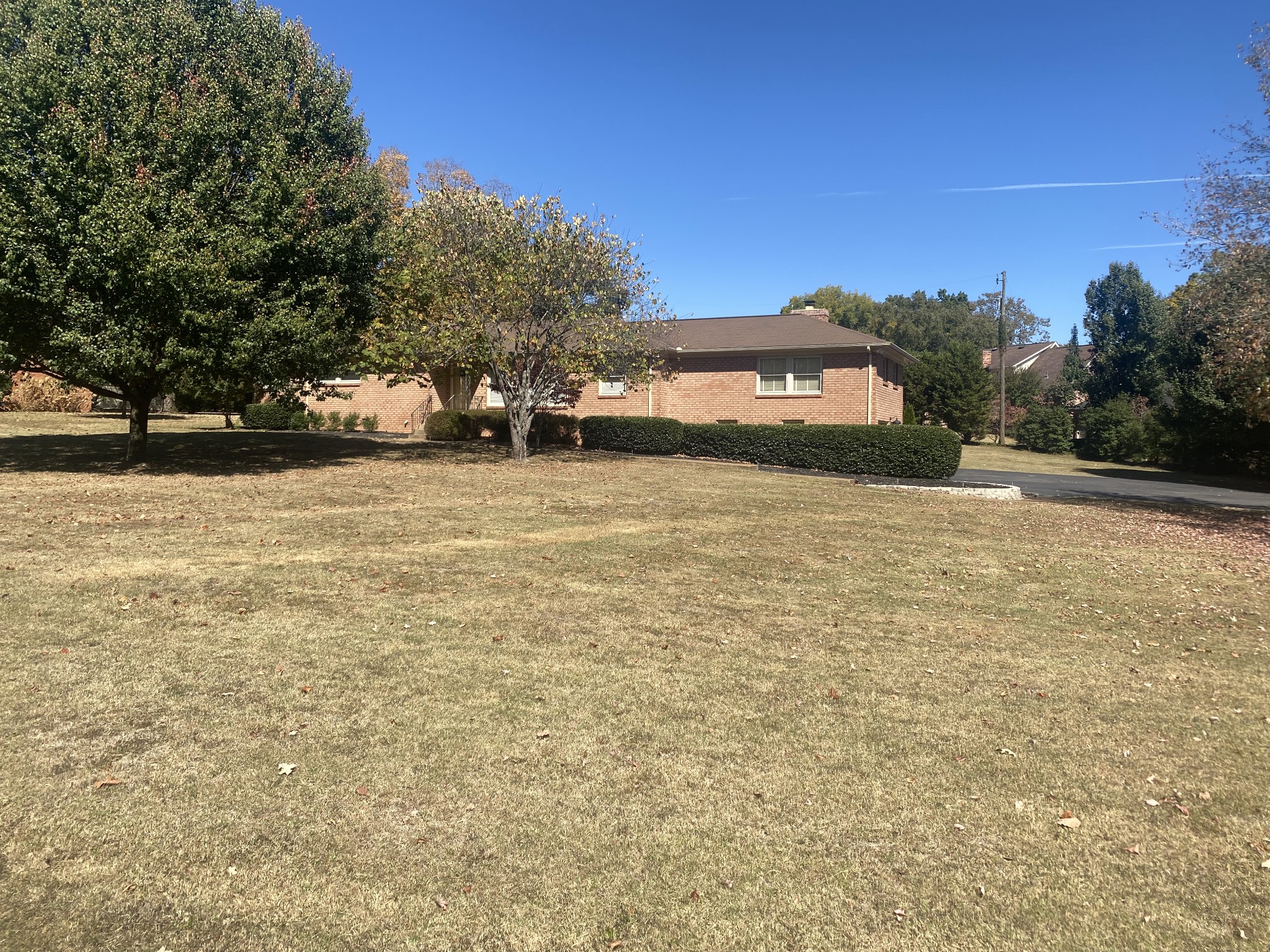 6046 Cargile Road Nashville, TN 37205 - Photo 2 of 24 a tall yellow building with trees in front of it