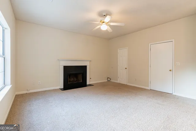 a view of hallway with closet and mirror