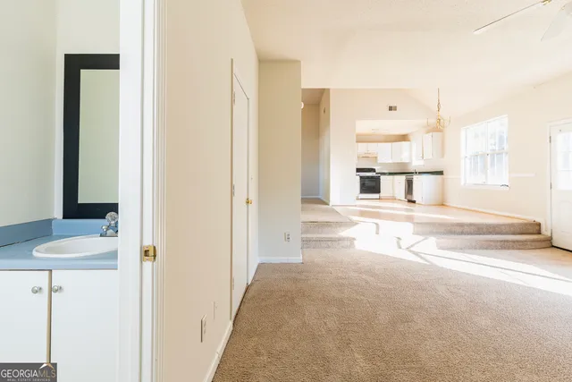 a view of a bedroom with wooden floor and windows