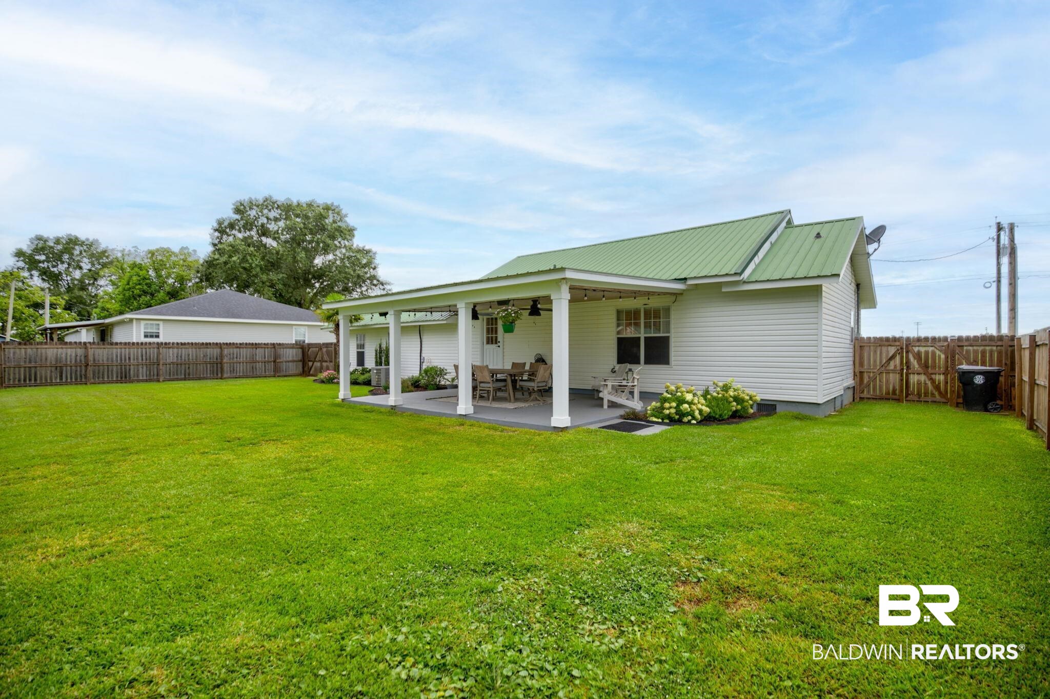 18732 Fairground Road Robertsdale, AL 36567 - Photo 34 of 46 Back of house featuring a patio and a yard