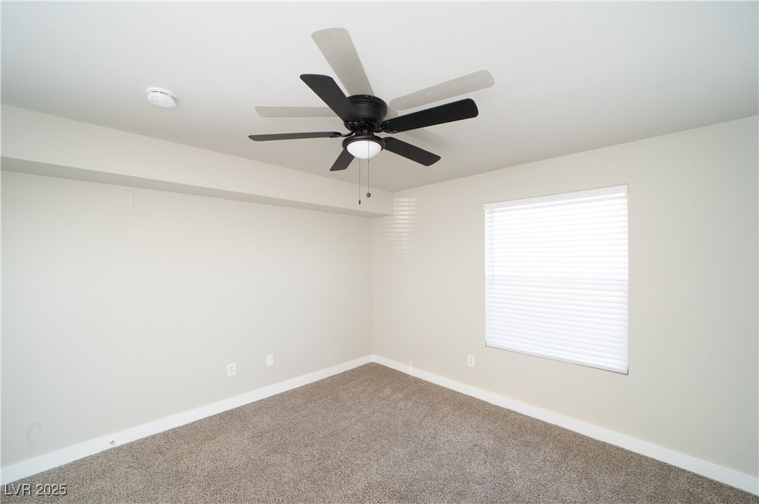 8101 West Flamingo Road, Unit 1057 Las Vegas, NV 89147 - Photo 17 of 38 Carpeted spare room with baseboards and a ceiling fan
