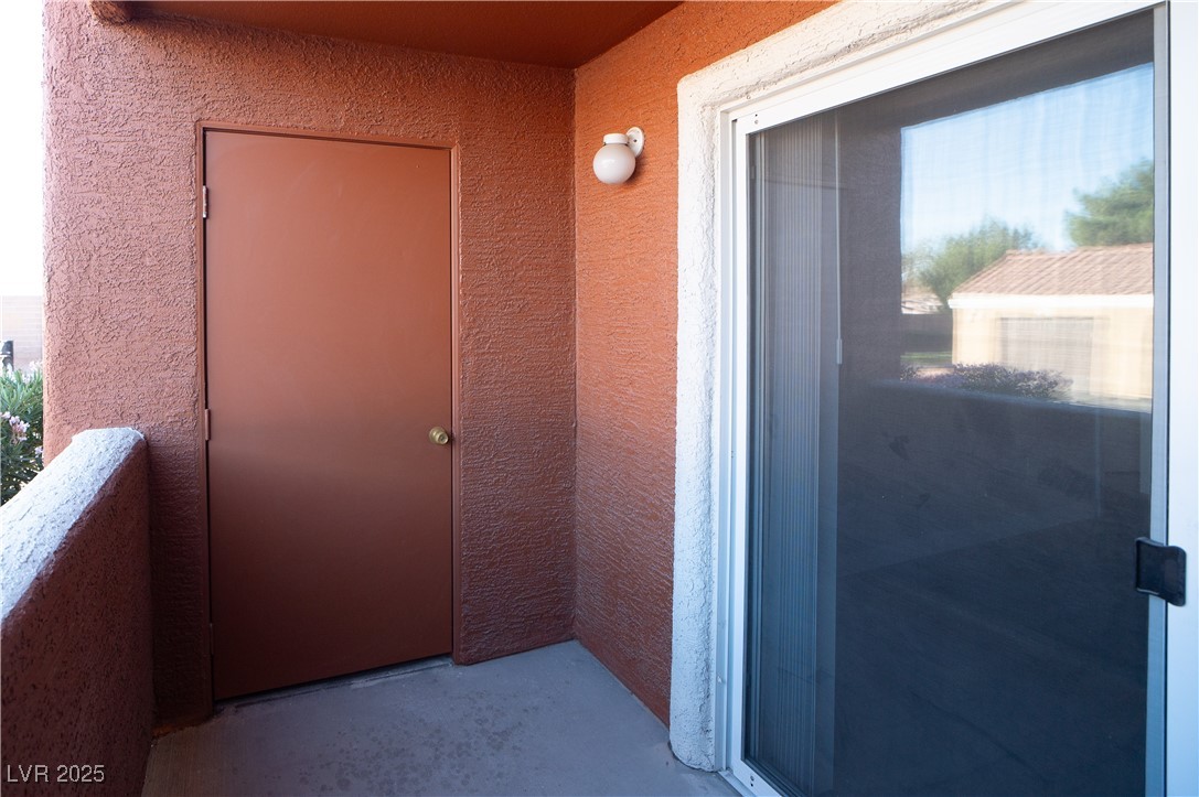 8101 West Flamingo Road, Unit 1057 Las Vegas, NV 89147 - Photo 21 of 38 Doorway to property with stucco siding