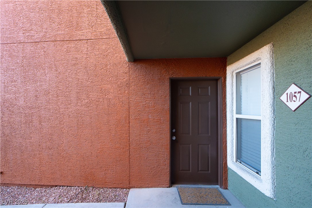 8101 West Flamingo Road, Unit 1057 Las Vegas, NV 89147 - Photo 25 of 38 View of exterior entry with stucco siding