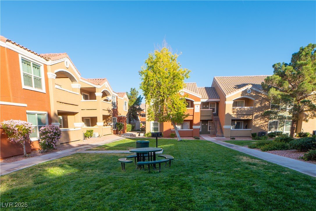 8101 West Flamingo Road, Unit 1057 Las Vegas, NV 89147 - Photo 33 of 38 View of property's community featuring a lawn, stairway, and a residential view