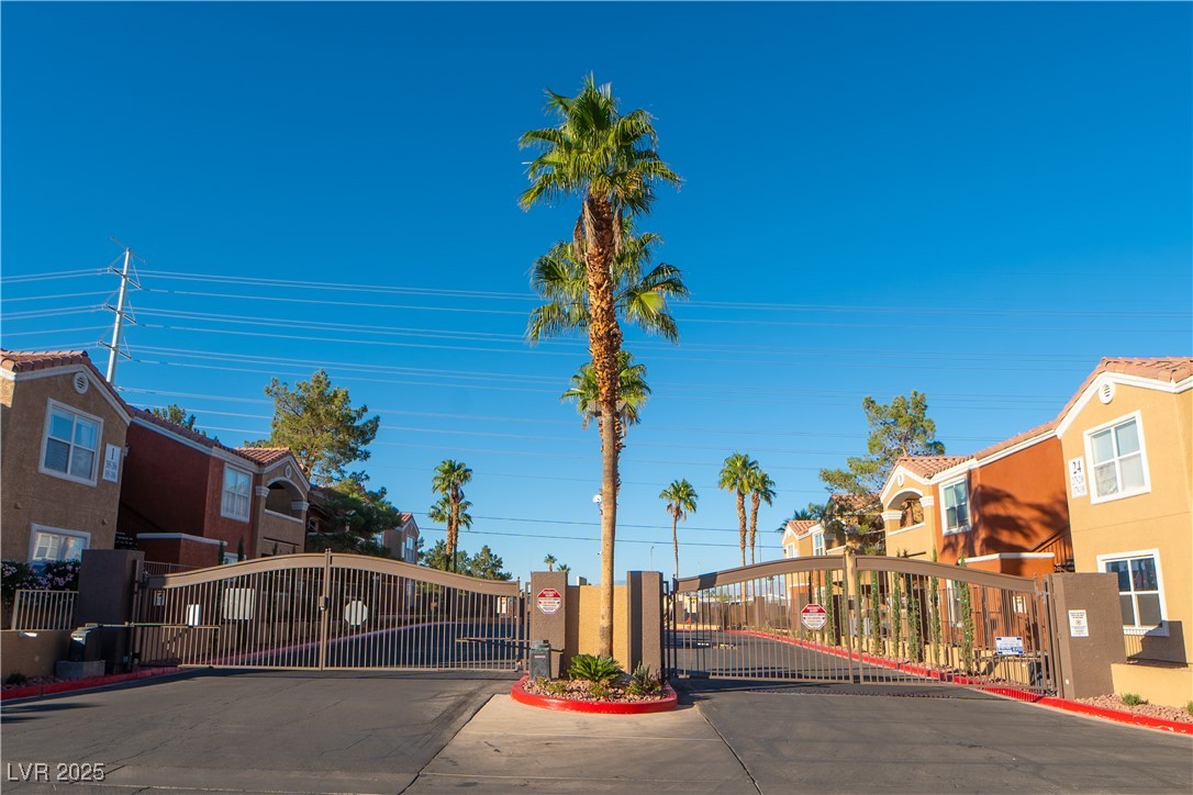 8101 West Flamingo Road, Unit 1057 Las Vegas, NV 89147 - Photo 36 of 38 View of street featuring a gate, curbs, a gated entry, and a residential view