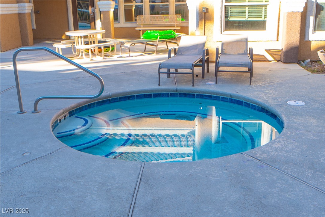 8101 West Flamingo Road, Unit 1057 Las Vegas, NV 89147 - Photo 37 of 38 View of pool with a community hot tub, a patio, and a pool