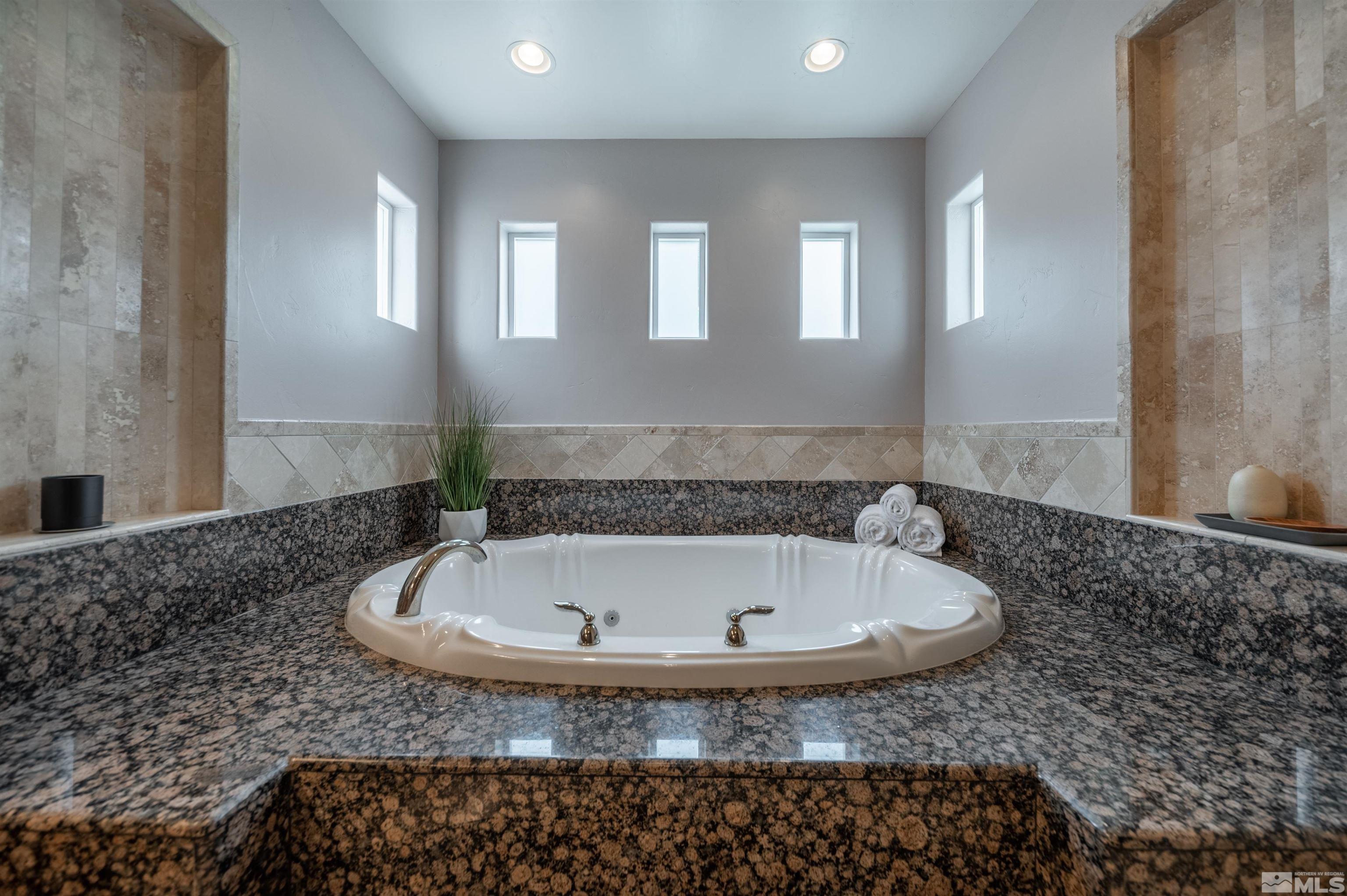 12880 Silver Wolf Road Reno, NV 89511 - Photo 13 of 35 a bath tub sitting in a bathroom