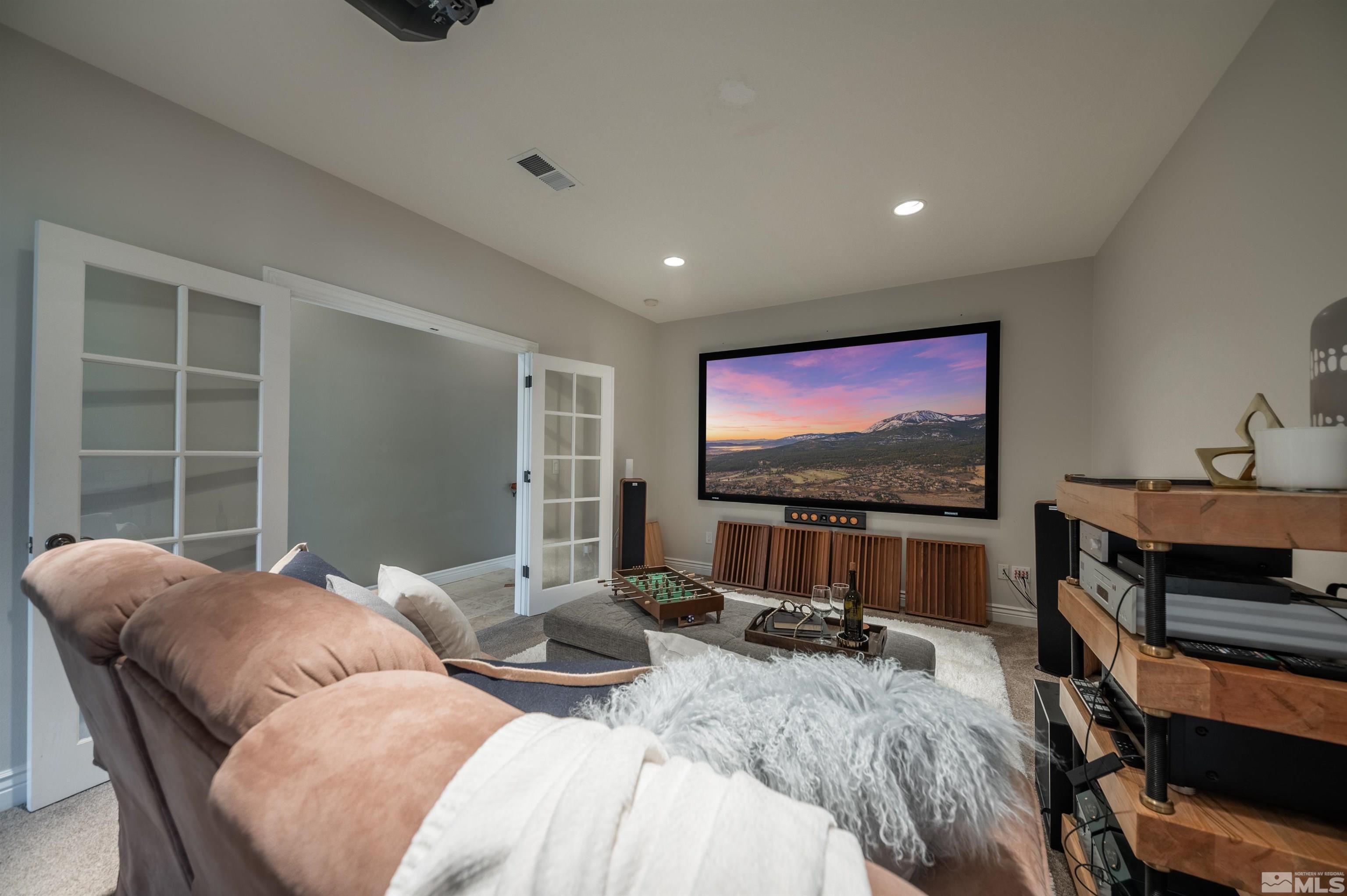 12880 Silver Wolf Road Reno, NV 89511 - Photo 14 of 35 a bedroom with furniture and a flat screen tv